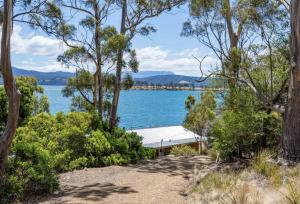 a view of a lake with a dock at The Gums - Bruny Island in Woodbridge