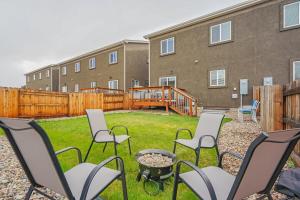 a group of chairs sitting in a yard in front of a building at Orchid Oasis - 2 Kings Foosball BBQ Fire Pit in Colorado Springs