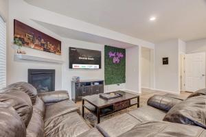 a living room with a couch and a fireplace at Orchid Oasis - 2 Kings Foosball BBQ Fire Pit in Colorado Springs