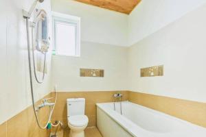 a bathroom with a toilet and a bath tub at Hoa Giấy Villa in Da Lat +20 photos