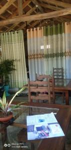 a dining room with a glass table and chairs at City Elephant Family Resort in Udawalawe +15 photos