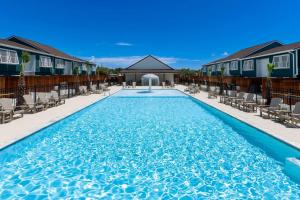 a large swimming pool with chairs and a building at C1 At Little Bay Landing in Rockport