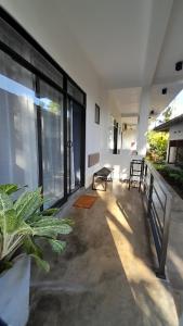 a living room with large windows and a plant at SriMany in Mirissa
