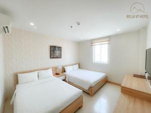 Postel nebo postele na pokoji v ubytování Bella Hotel Bai Sau Vung Tau