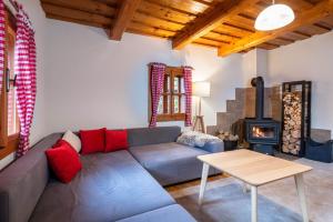 a living room with a couch and a wood stove at Traditional deer Cabin with Sauna - Chata Srňacie in Dolný Kubín