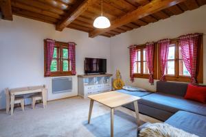 a living room with a couch and a table at Traditional deer Cabin with Sauna - Chata Srňacie in Dolný Kubín