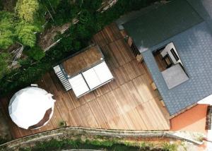 an overhead view of a boat on a wooden deck at ODEON Gongen松山市一組限定貸切グランピング in Horiechō