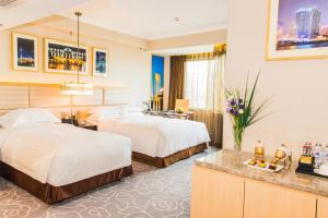 Voodi või voodid majutusasutuse Metropark Hotel Macau toas