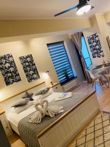 a bedroom with a large bed and a window at Studio Dear in Eforie Nord