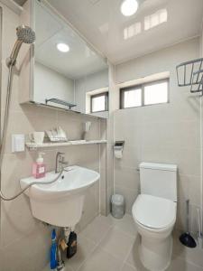 a bathroom with a white toilet and a sink at Haru Stay in Seoul
