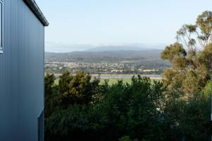 a view from the side of a house with trees at Cosy Riverside Escape with River Views in Inveresk