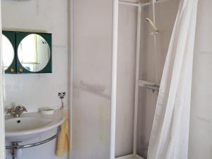 a bathroom with a sink and a shower with a mirror at Amazing Home In Vittsjö With 1 Bedrooms in Vittsjö