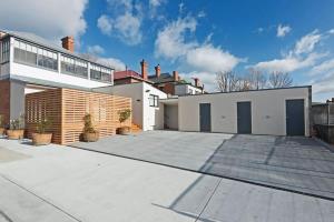 a house with a large driveway in front of it at The Little Lollyshop Apartment in Battery Point in Hobart