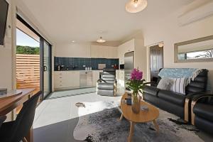 a living room with a couch and a table at The Little Lollyshop Apartment in Battery Point in Hobart