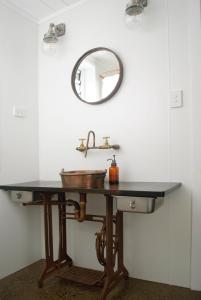 a bathroom with a sink and a mirror at The Eagle's Nest in Manilla +3 photos