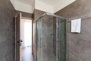 a bathroom with a shower with a glass door at Lotus Luxury Apartments in Kremasti +34 photos