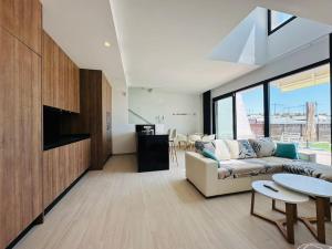 a living room with a couch and a table at Villa Finestrat Benidorm Golf y Playa in Cala de Finestrat