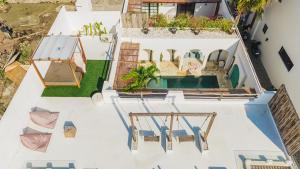 an aerial view of a house with a swimming pool at Villa Aurelia - 2 Bedrooms Rooftop Villa in Canggu in Canggu