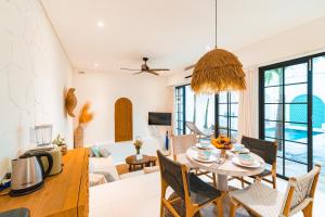 a living room and dining room with a table and chairs at Villa Aurelia - 2 Bedrooms Rooftop Villa in Canggu in Canggu