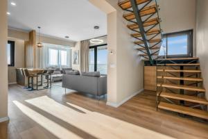 a living room with a staircase and a table at Majestic Skyline in Balta Albă