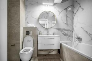 a bathroom with a toilet and a sink and a mirror at Majestic Skyline in Balta Albă +37 photos
