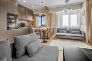 a living room with a couch and a table at Majestic Skyline in Balta Albă