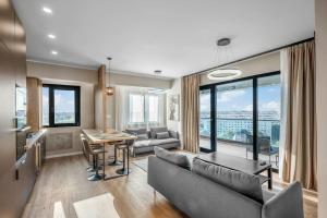 a living room with a couch and a table at Majestic Skyline in Balta Albă