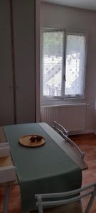 a room with a table with a plate on it at Appartement Bagnères-de-Luchon T2 nuitée-semaines in Luchon