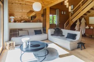 a living room with a couch and a table at Chalet Ilca in Thollon