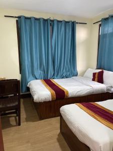 Postel nebo postele na pokoji v ubytování Holy Land Hotel Nepal