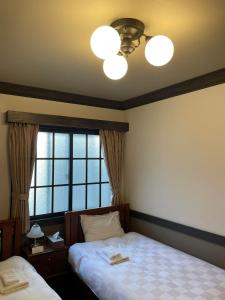Postel nebo postele na pokoji v ubytování Hotel Fukudaya