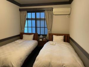 Postel nebo postele na pokoji v ubytování Hotel Fukudaya
