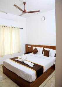 a bedroom with two beds and a ceiling fan at Angel Valley Inn in Vayittiri