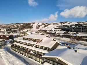 a resort in the snow with snow covered buildings at Bergo Leiligheter in Beitostøl