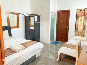 Katil atau katil-katil dalam bilik di Sastro Inn Syariah Hotel Malioboro
