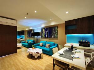 a living room with a blue couch and a table at D'Majestic Place Jalan Pudu in Kuala Lumpur