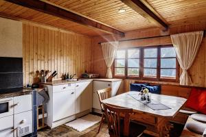 a kitchen with a table and chairs in a room at Flasswiesen Alm - ruhige Almhütte in Osttirol in Lienz