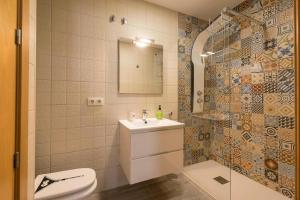 a bathroom with a toilet and a sink and a shower at Flamenco Soul in Chiclana de la Frontera +14 photos
