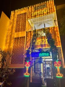 a building with christmas lights on the side of it at Sinna’s Homestay in Pondicherry