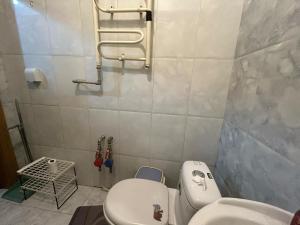 a bathroom with a toilet and a sink at Fully furnished, 1-bedroom apartment in Ulaanbaatar