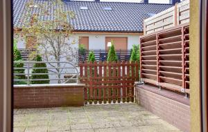 a wooden fence in front of a house at 1 Bedroom Cozy Home In Kolobrzeg in Kołobrzeg +12 photos