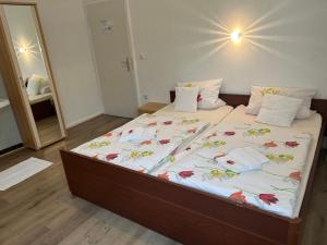 a bedroom with a large bed with flowers on it at Hotel Haus Schwan Köln in Cologne +40 photos