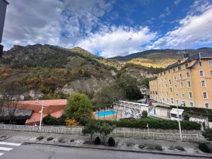 a view of a building and a mountain at Loft HATISAS in Brides-les-Bains