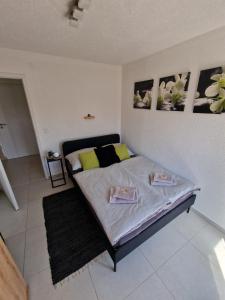 a bedroom with a bed with two plates on it at FewoSaric Apartment Marlon in Vir