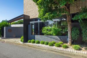 a building with a bunch of plants in front of it at WeBase KAMAKURA in Kamakura