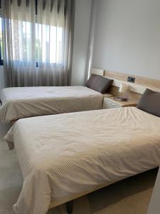 Postel nebo postele na pokoji v ubytování Oasis Beach El Raso Guardamar