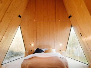 a bedroom in a tree house with large windows at 泊心域牧星营地 in Yongjiahe