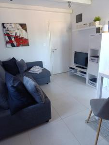 a living room with a blue couch and a tv at Fewo Saric Vir in Vir +13 photos