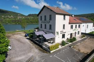 an aerial view of a building next to a lake at Au Moulin Du Pont in Samognat
