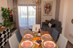 a dining room with a table and a couch at Casa Paraiso in Caleta De Fuste